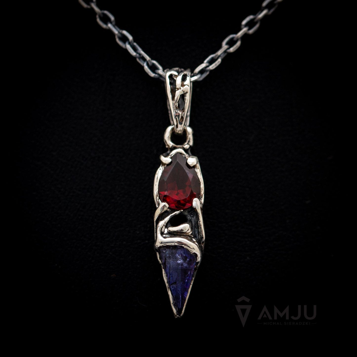 Raw Tanzanite crystal with pear-cut Garnet