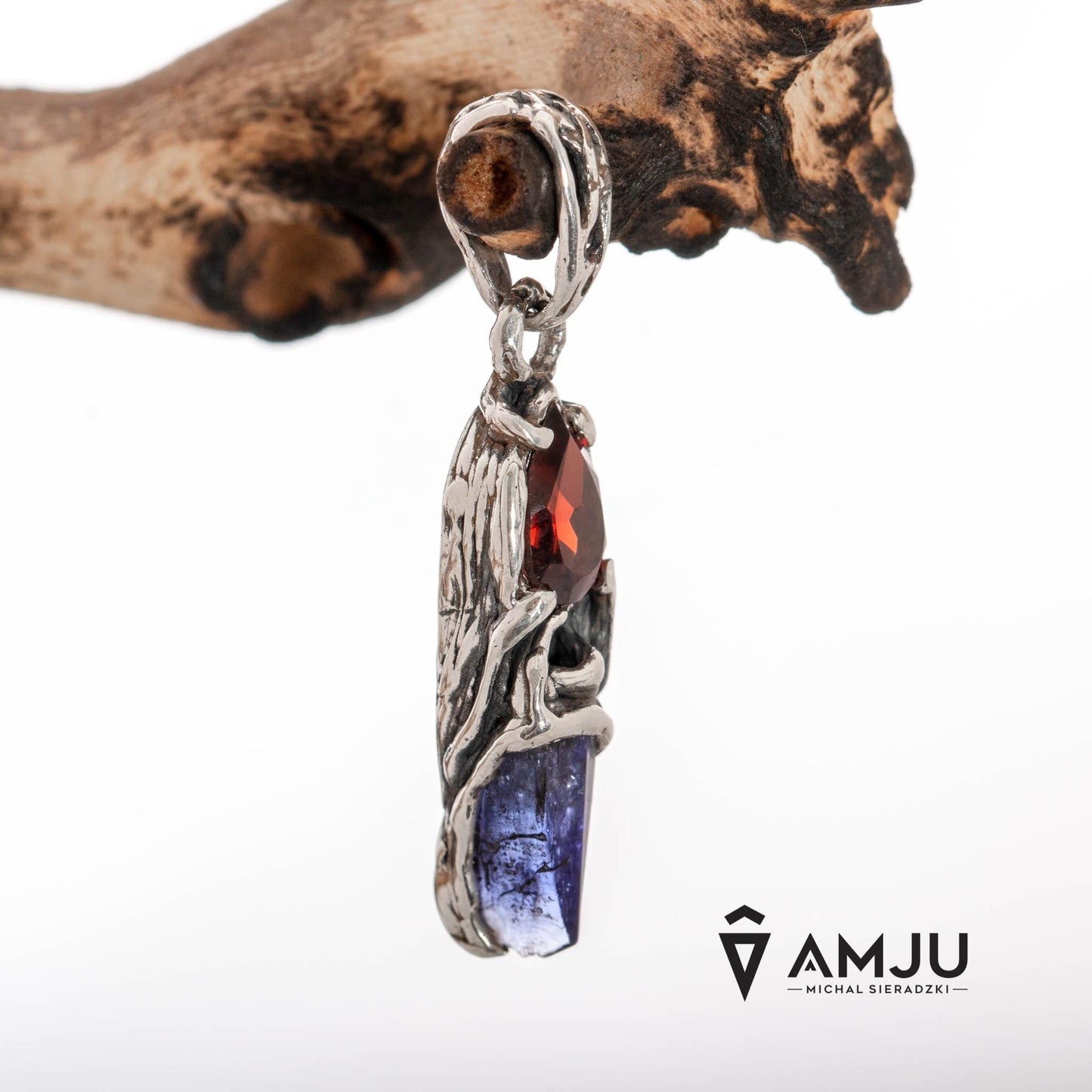 Raw Tanzanite crystal with pear-cut Garnet