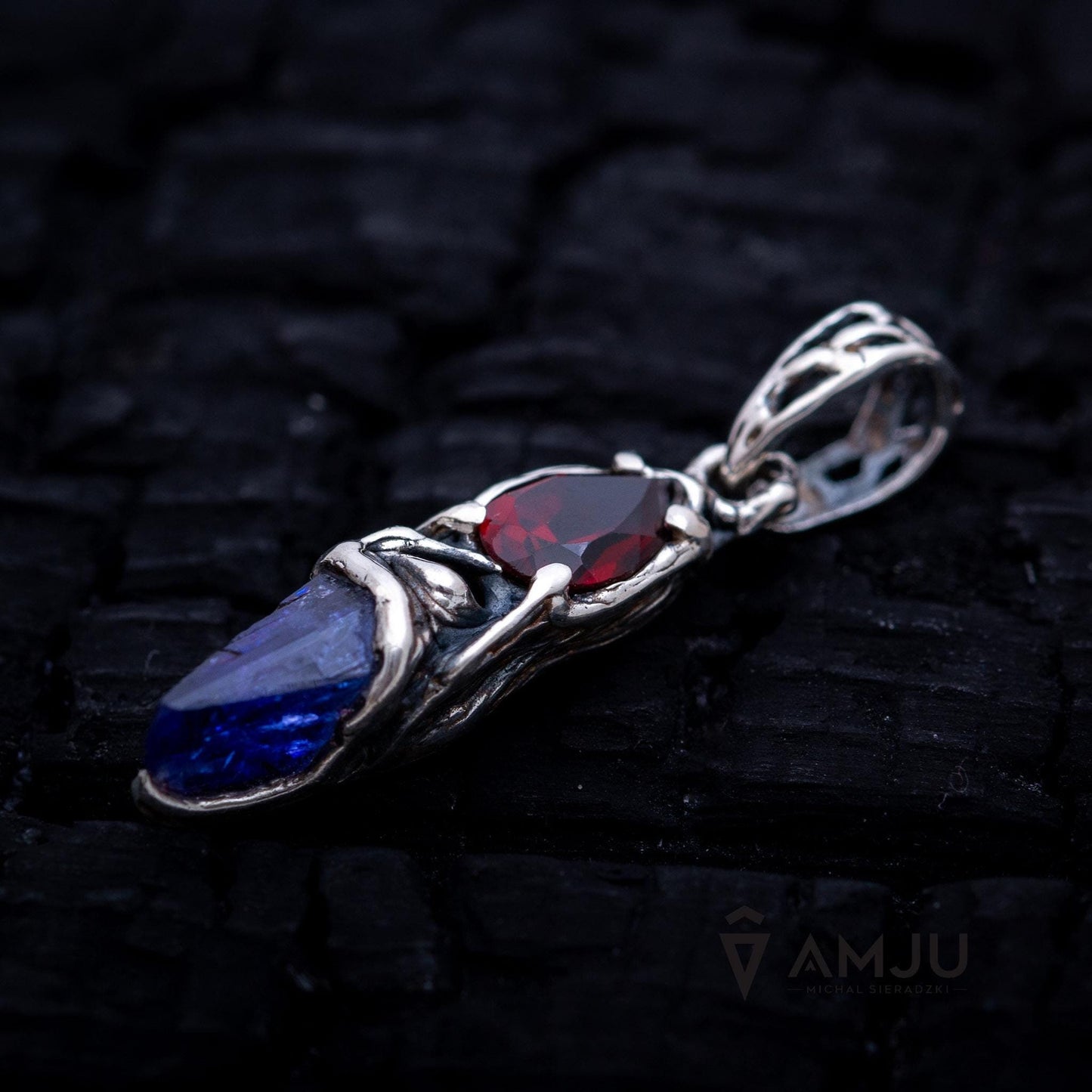 Raw Tanzanite crystal with pear-cut Garnet