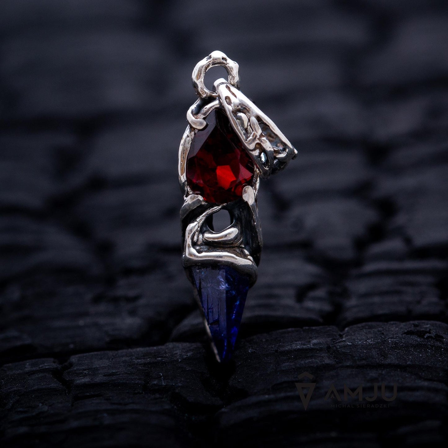 Raw Tanzanite crystal with pear-cut Garnet