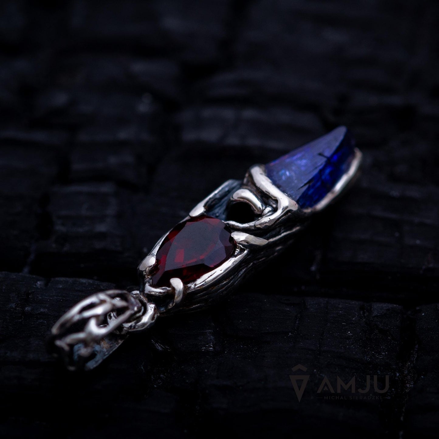 Raw Tanzanite crystal with pear-cut Garnet