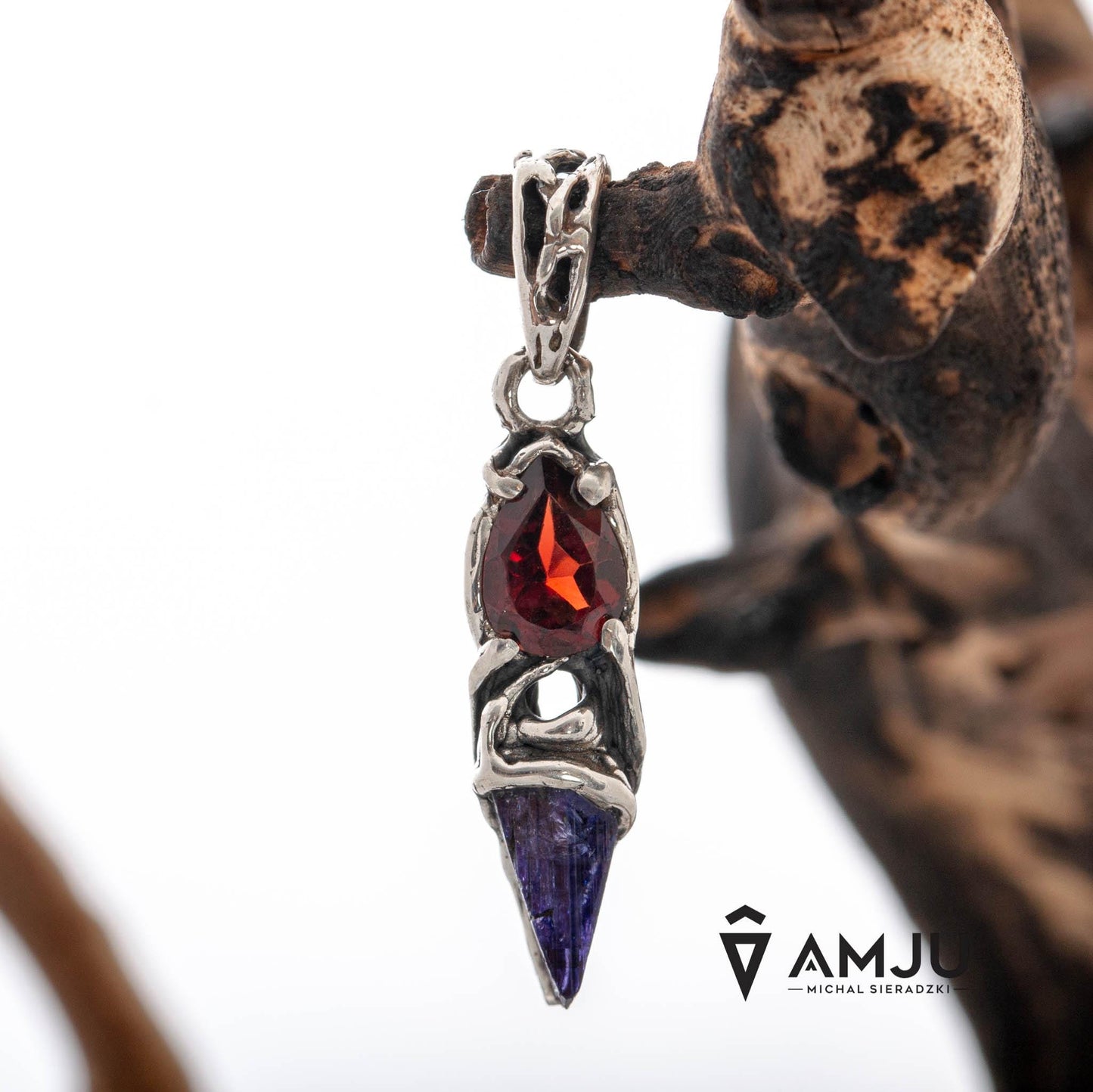 Raw Tanzanite crystal with pear-cut Garnet